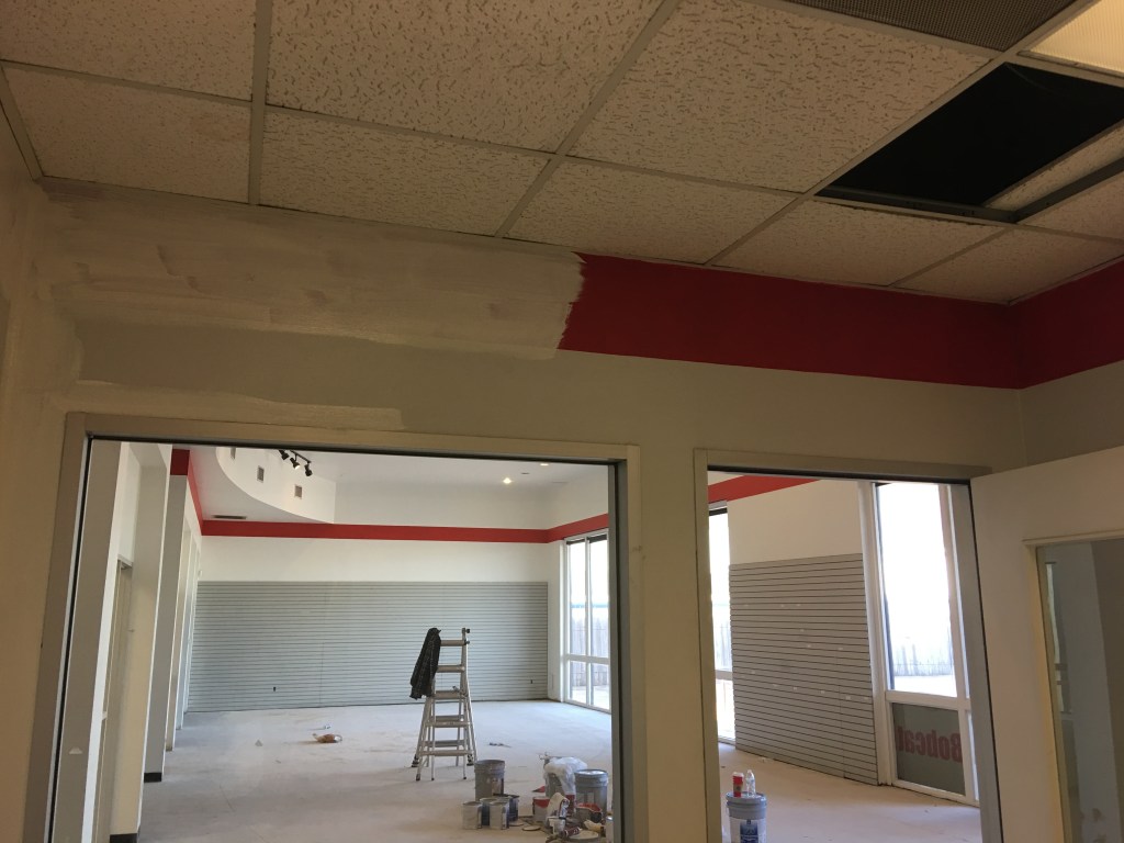 Painting a red stripe around the top of the walls to match the lobby.